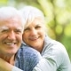 Older couple smiling with dentures