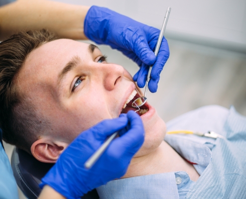 Boy at the dentist consultation. Checking and dental treatment in a clinic.